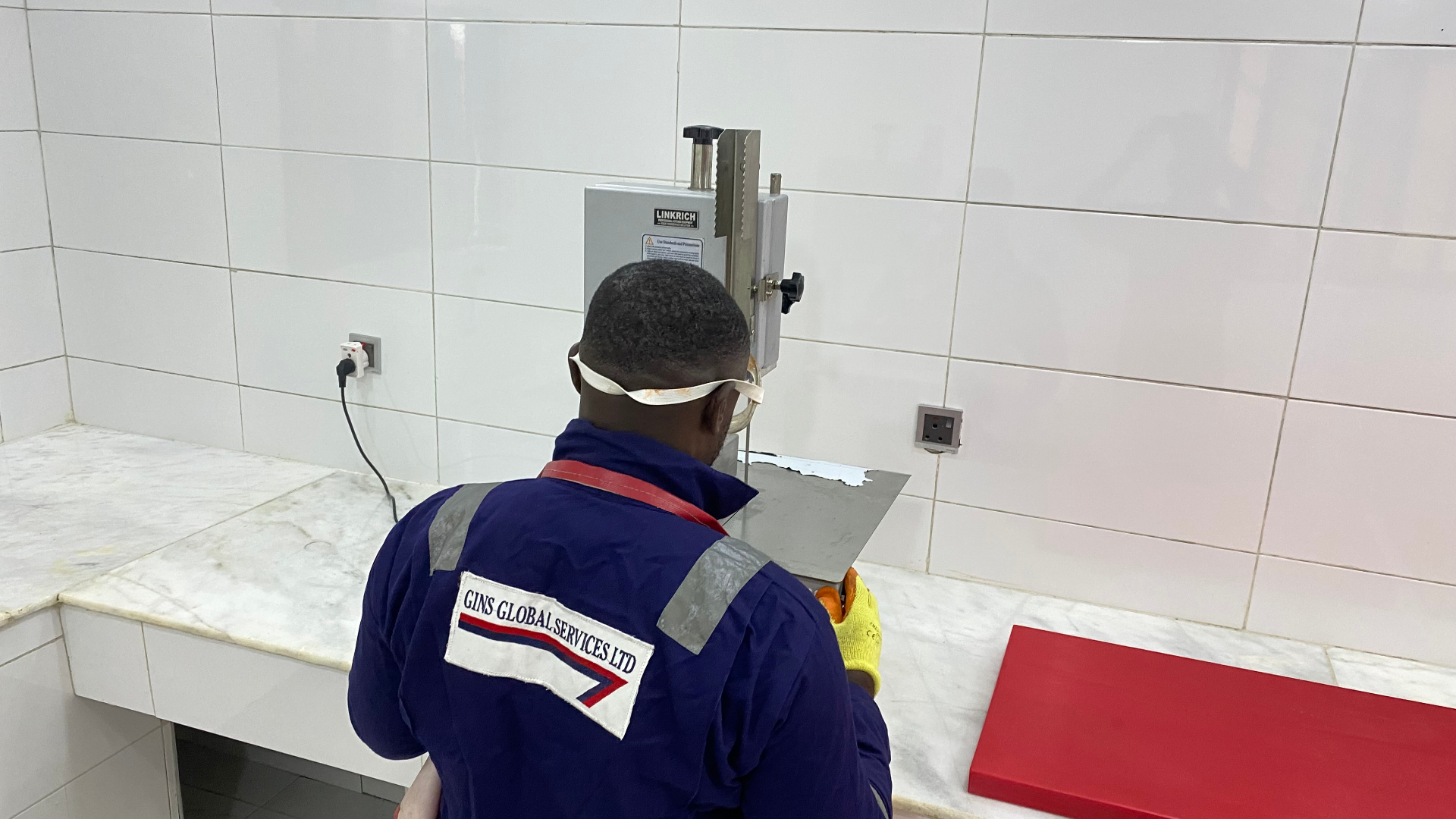 Colour-coded chopping boards and stainless equipment on the commissary floor