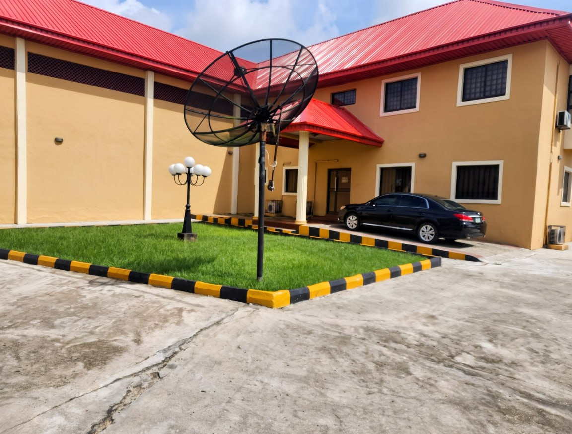 Administration building frontage with landscaped forecourt and parking bay