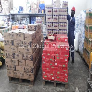 Warehouse operative marshalling palletised drinks and provisions