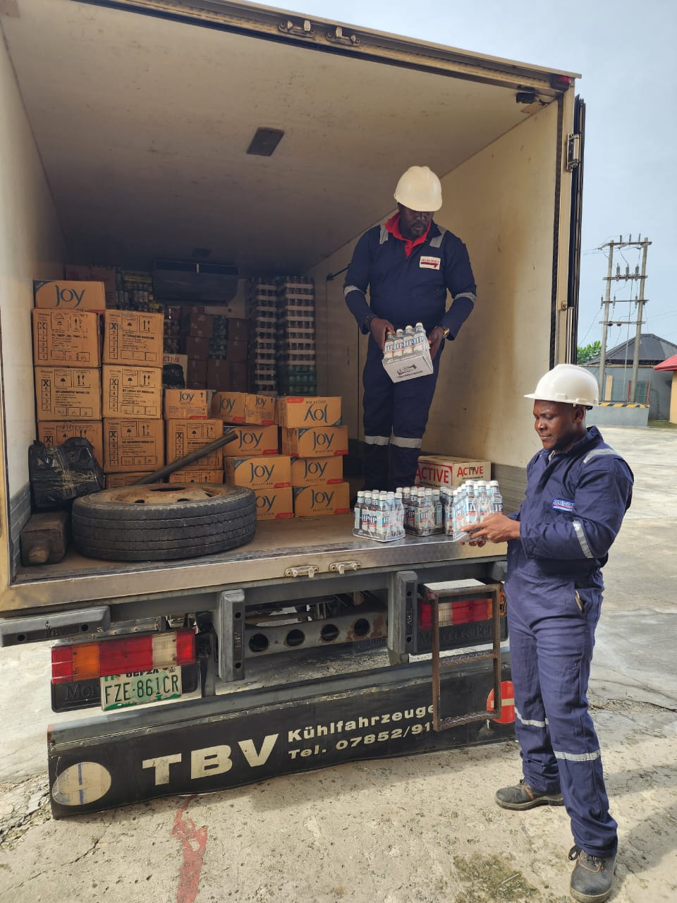 Crew loading bottled water and provisions into a refrigerated truck