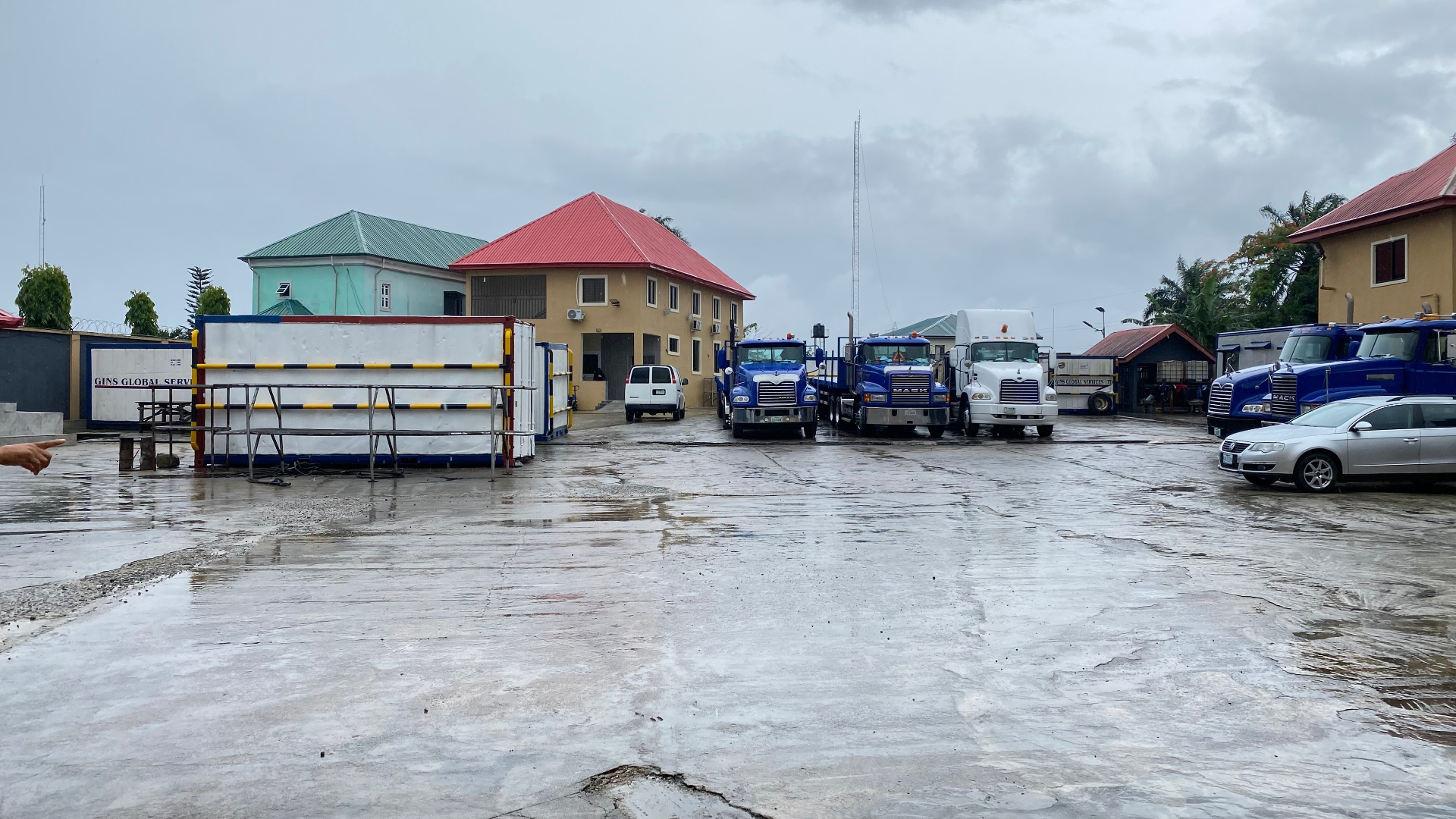 Mack tractor units and reefer container at the wet-weather yard